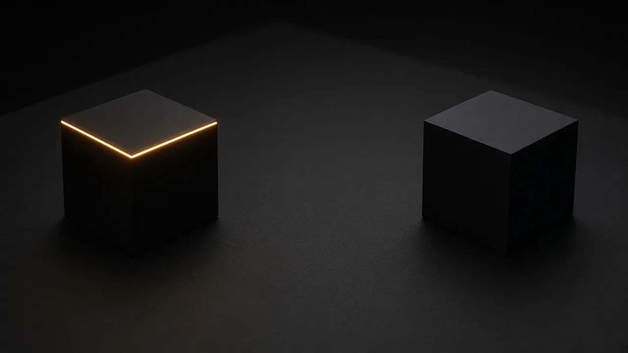 Two black cubes on a dark surface, far apart, the left cube edged in amber along the top and the right cube unlit